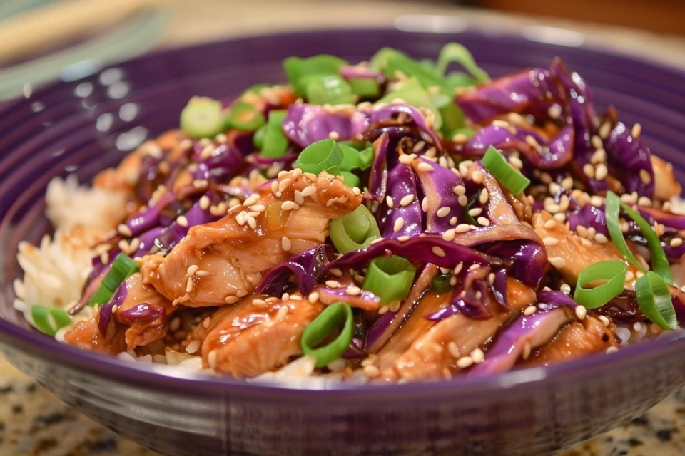 Chicken and cabbage stir fry in a wok with rice on the side.