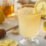 Refreshing natural Mounjaro detox drink in a glass mug with lemon and ginger.