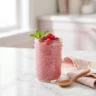 Chia jello recipe for weight loss in a glass jar topped with fresh raspberries, ready to eat 15 minutes before a meal